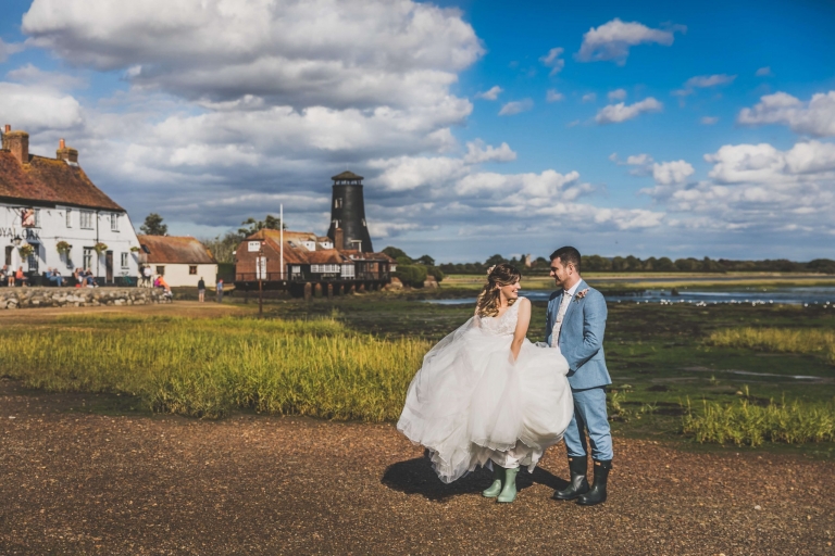 Married couple wearing wellies in harbour